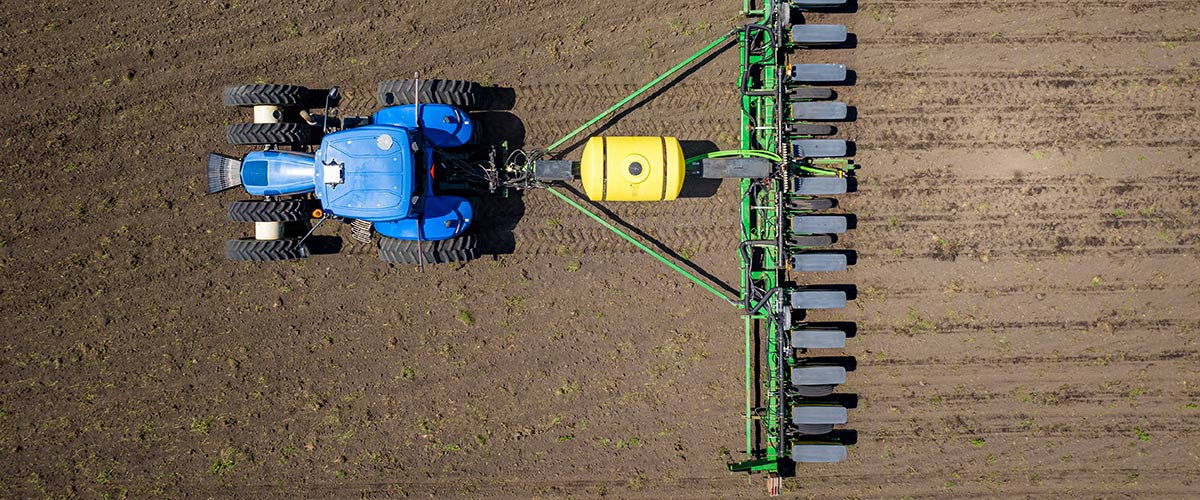 overhead view of a tractor pulling a planter through the field