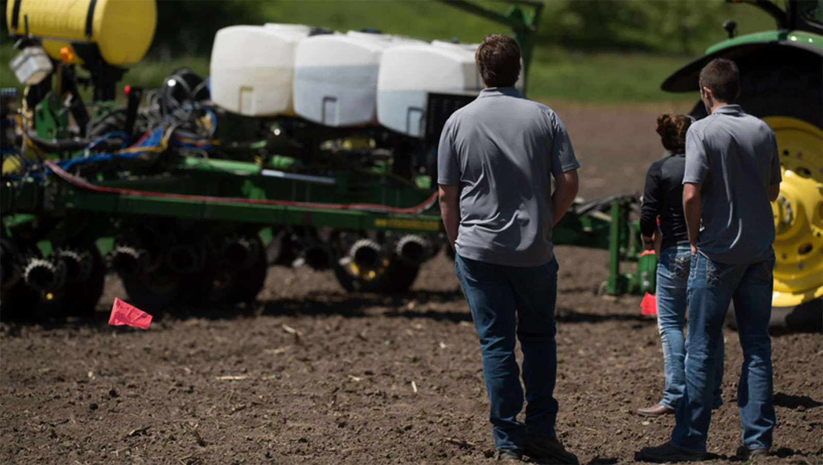 farmers standing near a planter