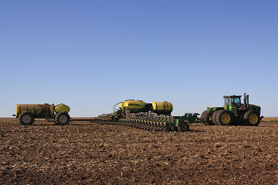 Yetter All Steer Cart being pulled behind a planter in a field