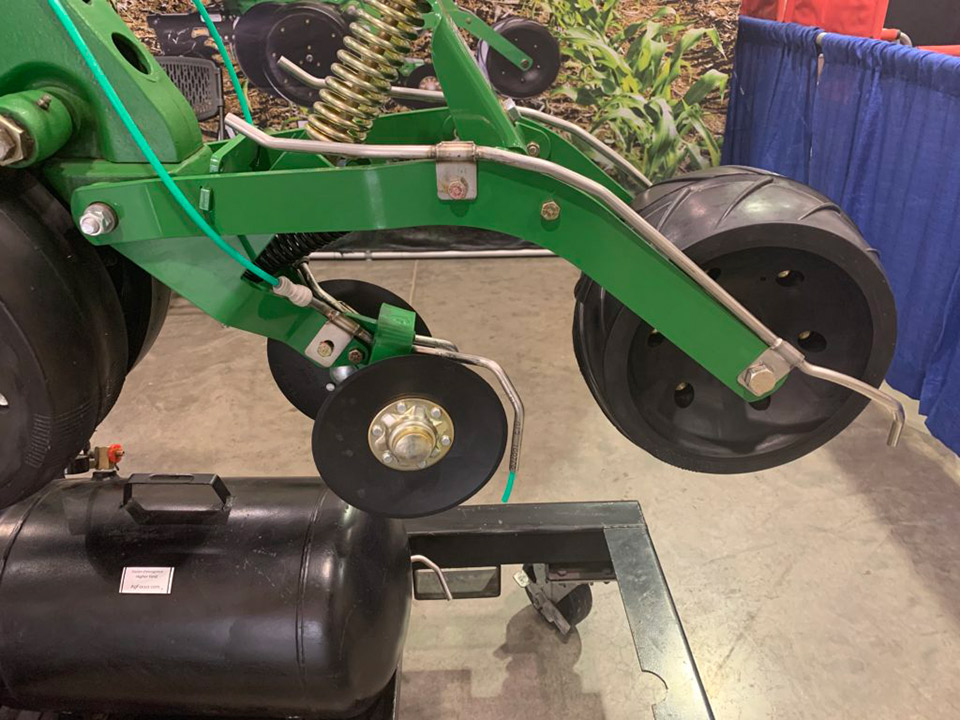 side view of the Ag Focus FastTrac 2 x 2 x 2 fertilizer system installed on a planter row unit